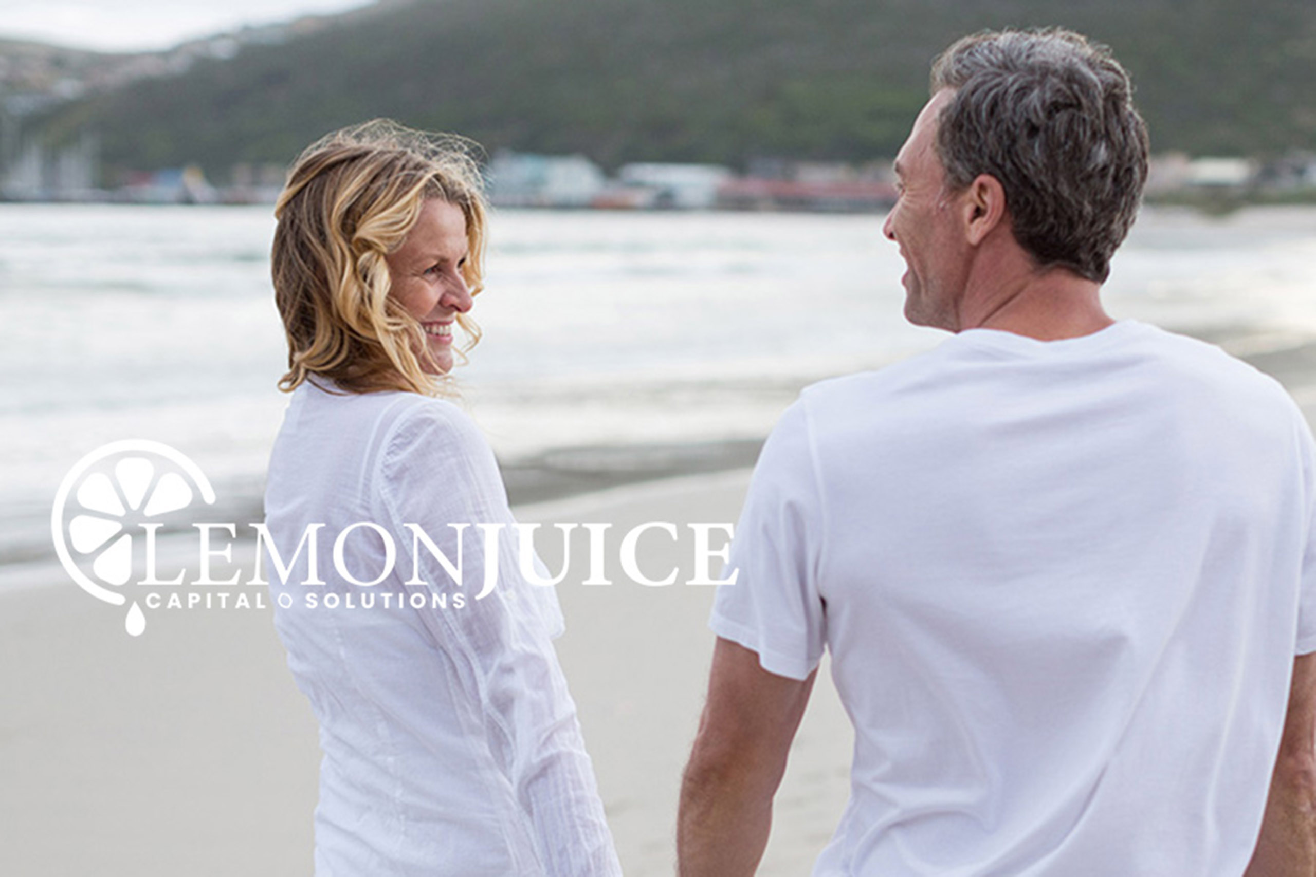Couple holding hands on beach.