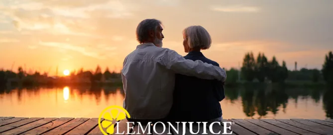 Older couple watching sunset by lake